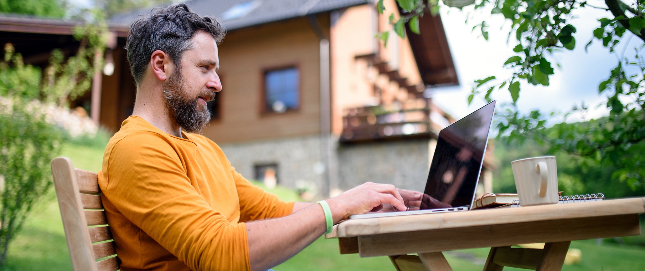 man sitting outside on computer